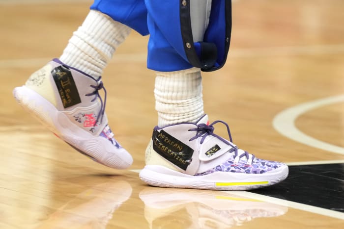View of Kyrie Irving's purple Nike shoes.